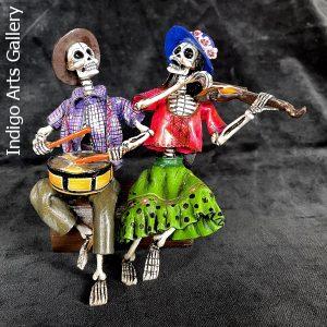 Two Musicians on a Log - calavera sculpture